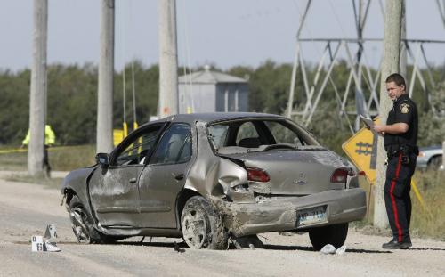 John Woods / Winnipeg Free Press / September 15/07- 070915  - A traffic cop investigates a fatal MVC on Ravelstone.   Cops were called to Ravelstone and Bienvenue to investigate the accident where one person died Saturday September 15/07.