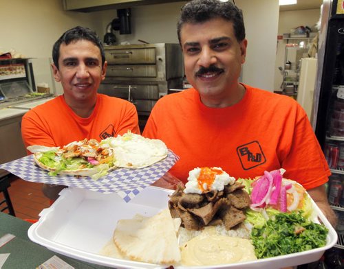 RESTAURANT REST REVIEW - Best Pizza and Donair. Edwar Shehata and Samy Ebrahim pose for a photo with chicken shwarma and donair platter from the restaurant. BORIS MINKEVICH/WINNIPEG FREE PRESS. JANUARY 19, 2015