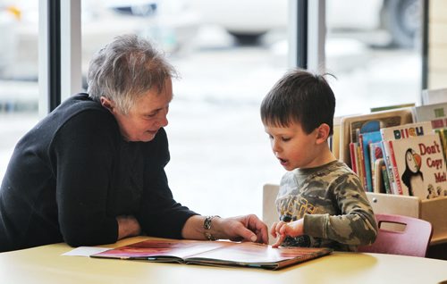 Shane Fisk, 4, reads a book with his grandmother Bernie Pelechaty during the grand opening of the new Charleswood Library Monday afternoon.  150119 January 19, 2015 Mike Deal / Winnipeg Free Press