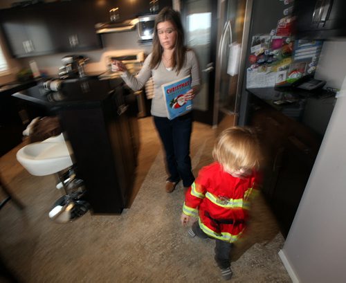 Four yr old Cian Anaka moves one way while mom Kristi gestures the other Monday. See Mary Agnes story re: Child Care. January 19, 2015 - (Phil Hossack / Winipeg Free Press)