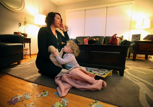 Two and a half yr old Vera stays close to mom Jamie Slight Monday. See Mary Agnes story re: Child Care. January 19, 2015 - (Phil Hossack / Winipeg Free Press)
