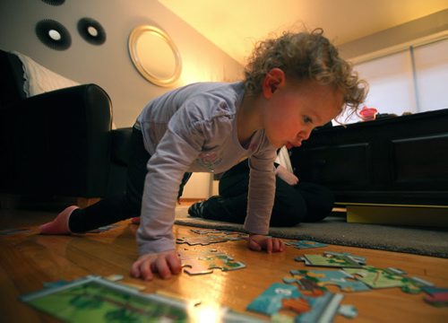 Two and a half yr old Vera  Slight plays on the living room floor Monday. See Mary Agnes story re: Child Care. January 19, 2015 - (Phil Hossack / Winipeg Free Press)