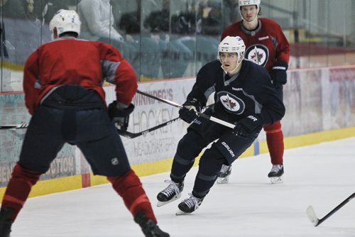 Winnipeg Jets' Mark Scheifele (55) chases after the puck during practice at the MTS IcePlex Tuesday morning.  150120 January 20, 2015 Mike Deal / Winnipeg Free Press