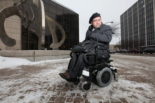 Lawyer Peter Tonge poses in front of the Law Courts building with his rented power chair that he pays for while he waits for his to be fixed. See Carol Sanders story.   Jan 20 / 2014  Ruth Bonneville / Winnipeg Free Press.