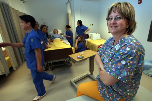 Instructor Nancy Scott (right) poses with her class of health care aides at Herzing College Tuesday. See Alex Paul's story re: "Nursing home health-care aides need more training, suffer worrisome burnout: study"  January 20, 2015 - (Phil Hossack / Winnipeg Free Press