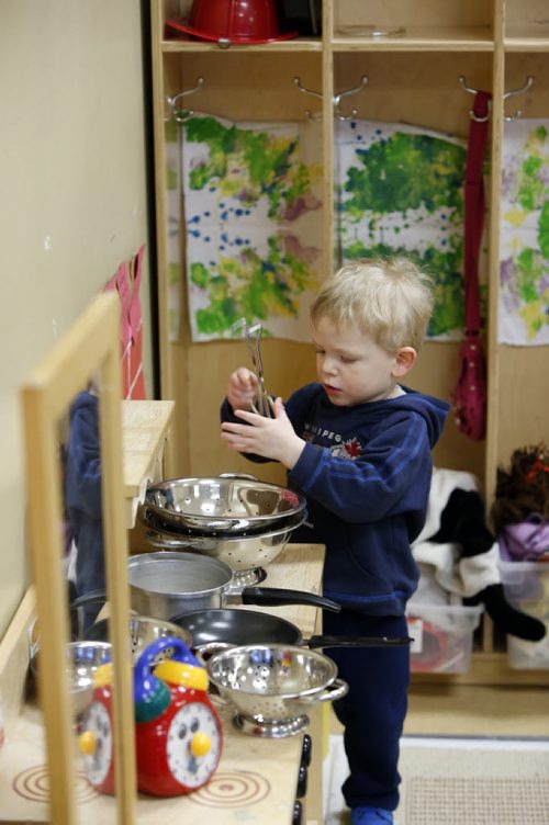 49.8 Daniel works in the play kitchen in the  Sunny Mountain Day Care Centre. Mary Agnes Welch story. Wayne Glowacki/Winnipeg Free Press Jan. 21 2015