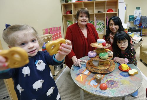 49.8   Director Debra Page,left, and Manager Claire Ferrer with children Zoey with plastic pretzels and Mary in the  Sunny Mountain Day Care Centre. Mary Agnes Welch story. Wayne Glowacki/Winnipeg Free Press Jan. 21 2015