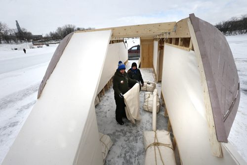 Artists Chris Fredrickson and Sarah Neville complete the repairs vandals caused to the Chris and Kine Artist Collective's "The York Boat" Gallery on the Frozen River. It is located along the Red River Mutual Trail on the Red River near the fork in the river. . The art gallery will feature work Chris, Sarah and Anna Frances Robinson and Christopher Janes. The opening reception is Jan.22 at 7pm.   Alex Paul story. Wayne Glowacki/Winnipeg Free Press Jan. 21 2015