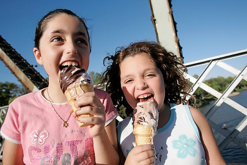 BORIS MINKEVICH / WINNIPEG FREE PRESS  070916 Stephanie Kalo,8, and her sister Emily,6, enjoy some ice cream on the BDI Bridge.
