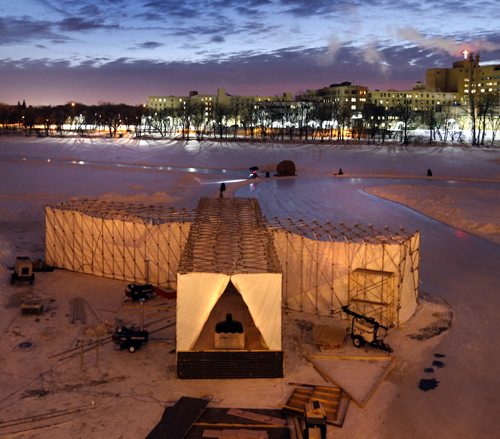 The sun rises Thursday morning behind the  RAW:almond winter fine dining experience structure on the frozen Assiniboine River where it meets the Red River. The structure designed this year by UK architects OS31 is open until Feb.11.   Wayne Glowacki/Winnipeg Free Press Jan. 22 2015