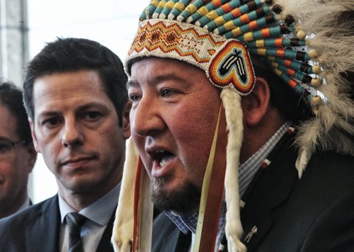 Grand Chief Derek Nepinak addresses the media regarding racism in Winnipeg while Mayor Brian Bowman listens in background. He was joined by members from across the community including; Elder Harry Bone, Grand Chief Derek Nepinak, Assembly of Manitoba Chiefs, Jamie Wilson, Treaty Commissioner, Treaty Relations Commission of Manitoba, Police Chief Devon Clunis, Honourable Kevin Chief, Minister of Jobs & the Economy, and Minister responsible for relations with the City of Winnipeg, Dr. David Barnard, President and Vice-Chancellor of the University of Manitoba, Dr. Annette Trimbee, President and Vice Chancellor at the University of Winnipeg, Julie Harper, Mother of Rinelle Harper, Michael Champagne and Althea Guiboche amongst others.  150122 January 22, 2015 Mike Deal / Winnipeg Free Press