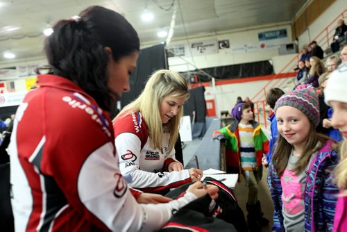 Olympic gold medalist  curler, Jennifer Jones and Jill Officer sign autographs for young curlers  at the Winkler Arena  Friday after Jones and her team won their match against Robertson. Little girl in pic is a young curler - Hope Friesen.  Jan 23, 2015 Ruth Bonneville / Winnipeg Free Press