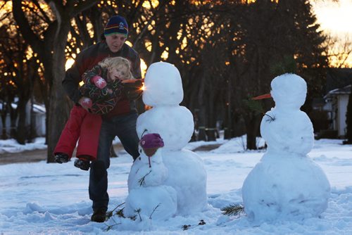 Picture Perfect Day-Mick Mullen with his grand daughter Livinia Bradbury on Mulvey Ave building snowmen in their front yard enjoying Winnipegs unseasonably warm weather today- Standup Photo- Jan 23, 2015   (JOE BRYKSA / WINNIPEG FREE PRESS)