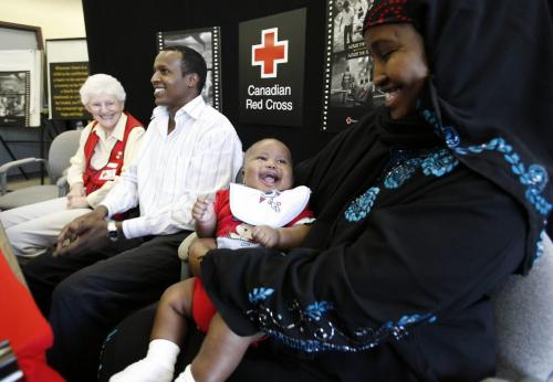 John Woods / Winnipeg Free Press / September 17/07- 070917  -  Ayaan Ahmed Jama, a Somalian refugee, smiles at her baby son Abdikani during a press conference at the Canadian Red Cross in Winnipeg Monday, September 17/07.      Ayaan with assistance from translator Mustafa Ibrahim and volunteer Elizabeth Gehman tells her story.  Ayaan has found out that her mother survived the conflict in Somalia.
