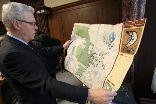 Premier Greg Selinger looks at a map at the send off  for new nomination by the The Pimachiowin Aki Corp. to UNESCO in Paris, France this week in support of a bid by five First Nations, and the Manitoba and Ontario governments to have a vast track of cultural landscape and boreal forest declared a UNESCO World Heritage Site..-See Bruce Owen story- Jan 26, 2015   (JOE BRYKSA / WINNIPEG FREE PRESS)