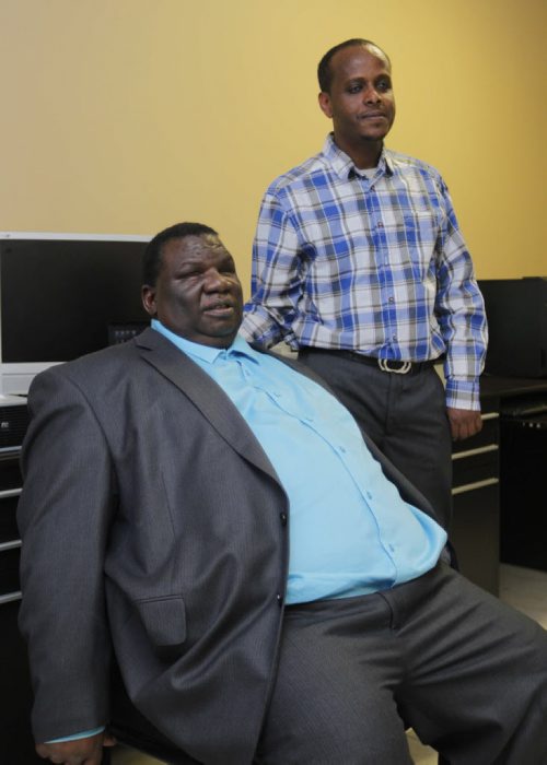 LOCAL -Canadian Multicultural Disability Centre. Pix of executive director Dr. Zephania Matanga, left, and former client Getachew Addgeh. The centre helps refugees with PTSD and other newcomers stuggling with physical, mental and emotional disabilities. BORIS MINKEVICH / WINNIPEG FREE PRESS  Jan. 26, 2015