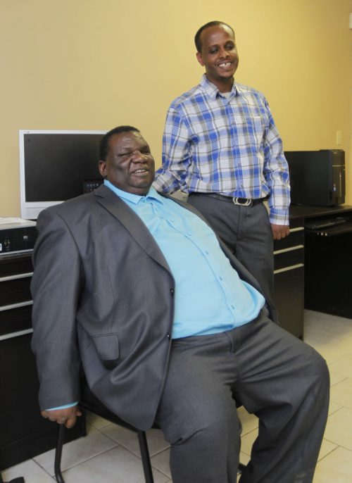 LOCAL -Canadian Multicultural Disability Centre. Pix of executive director Dr. Zephania Matanga, left,  and former client Getachew Addgeh. The centre helps refugees with PTSD and other newcomers stuggling with physical, mental and emotional disabilities. BORIS MINKEVICH / WINNIPEG FREE PRESS  Jan. 26, 2015
