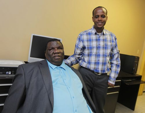 LOCAL -Canadian Multicultural Disability Centre. Pix of executive director Dr. Zephania Matanga, left, and former client Getachew Addgeh. The centre helps refugees with PTSD and other newcomers stuggling with physical, mental and emotional disabilities. BORIS MINKEVICH / WINNIPEG FREE PRESS  Jan. 26, 2015
