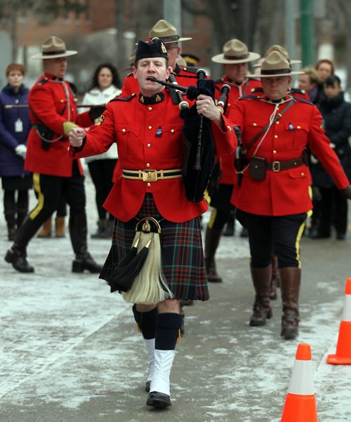 An RCMP Honor Guard is piped out the the memorial at the Portage ave "D" Division's Winnipeg HQ to lay a wreath in memorium of Cst David Wyn, who was shot and killed in Alberta last week. See story. January 26, 2015 - (Phil Hossack / Winnipeg Free Press)