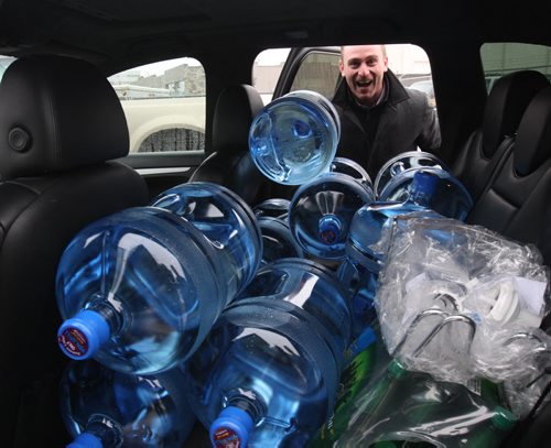 Nick Cringan from Pattison Outdoor Advertising stuffs a car full of water for the office at WaterMart 866a Kenaston Hyw- The City of Winnipeg issued a boil water advisory sending people scrambling to retailers for fresh water-See Adam Wazny story - Jan 28, 2015   (JOE BRYKSA / WINNIPEG FREE PRESS)