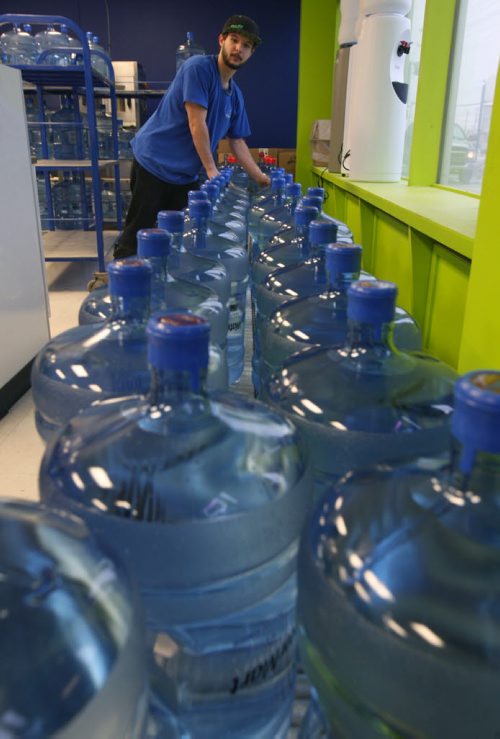 Logan Heleig is a busy employee at WaterMart 866a Kenaston Hyw- The City of Winnipeg issued a boil water advisory sending people scrambling to retailers for fresh water-See Adam Wazny story - Jan 28, 2015   (JOE BRYKSA / WINNIPEG FREE PRESS)