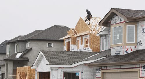 Construction continues in the new Waterford Green housing development.  Waterford Green is a new housing development located off Keewatin Street between Inkster Boulevard and Jefferson Avenue. 150128 January 28, 2015 Mike Deal / Winnipeg Free Press