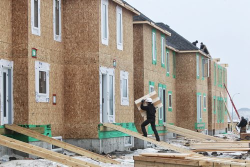 Construction continues in the new Waterford Green housing development.  Waterford Green is a new housing development located off Keewatin Street between Inkster Boulevard and Jefferson Avenue. 150128 January 28, 2015 Mike Deal / Winnipeg Free Press
