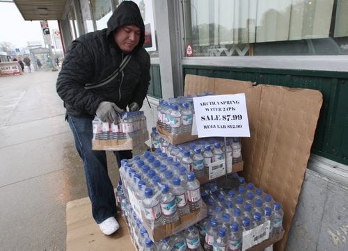 Entrepreneurial Efforts- Foodfare owner Husni Zeid is selling water on his sidewalk in front of his store.- With yesterdays boil water advisory by the City Of Winnipeg which continues- finding bottled water for sale has become a challenge- See Adam Wazny story- Jan 28, 2015   (JOE BRYKSA / WINNIPEG FREE PRESS)