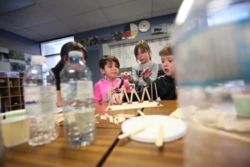 Victory School students Charli McKay (left), Emily Rempel (centre) and Max Balzer  work on a project surrounded  by dixie cups and water bottles Wednesday afternoon due to the boil water advisory by the City of Wpg.  See story.   Jan 28, 2015 Ruth Bonneville / Winnipeg Free Press
