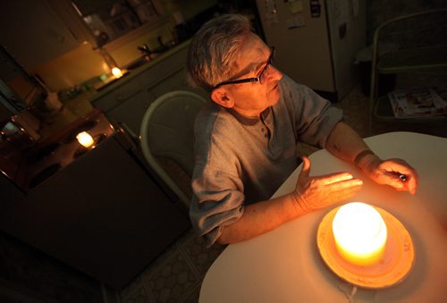 Auschwitz survivor Morris Faintuch sits in his kitchen lit by candlelight as he gives an interview about his experience at the Nazi death camp. See Randy Turner story. January 28, 2015 - (Phil Hossack / Winnipeg Free Press)