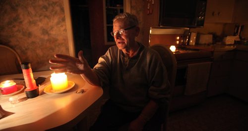 Auschwitz survivor Morris Faintuch sits in his kitchen lit by candlelight as he gives an interview about his experience at the Nazi death camp. See Randy Turner story. January 28, 2015 - (Phil Hossack / Winnipeg Free Press)