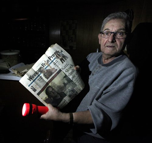 Auschwitz survivor Morris Faintuch pulls out an old newpaper clipping done 10 years ago about his experience at the Nazi death camp. See Randy Turner story. January 28, 2015 - (Phil Hossack / Winnipeg Free Press)