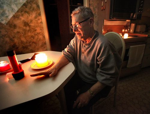 Auschwitz survivor Morris Faintuch sits in his kitchen lit by candlelight as he gives an interview about his experience at the Nazi death camp. See Randy Turner story. January 28, 2015 - (Phil Hossack / Winnipeg Free Press)