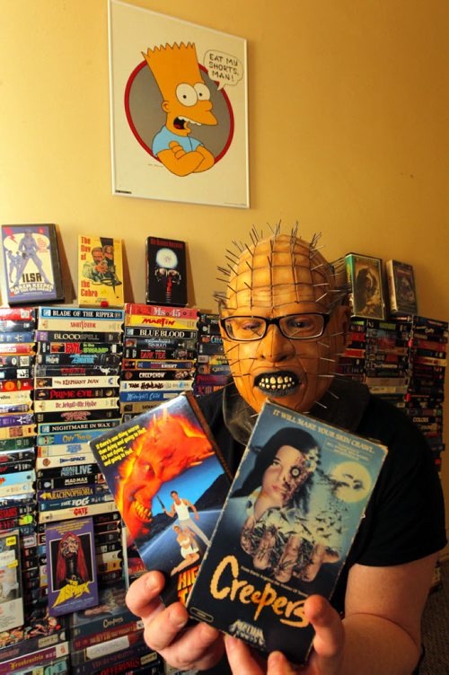 ENT- Sanderson- Winnipeg Cult VHS club. Andrew Sigfusson has this awesome collection of slasher films on VHS tape. Here he wears a scary mask. BORIS MINKEVICH / WINNIPEG FREE PRESS  Jan. 28, 2015