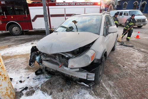Lost Control- A Firefighter sweeps up debris from a single vehicle mva at Maryland St and Ellice Ave downtown Winnipeg Thursday-Standup Photo- Jan 29, 2015   (JOE BRYKSA / WINNIPEG FREE PRESS)