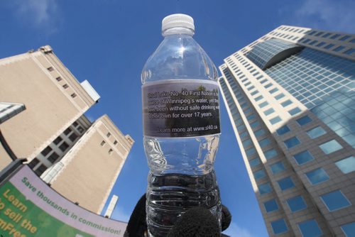 A small group of concerned citizens handed out bottles of water with a statement on the labels to highlight the irony of a 17-Year Long Boil Water Advisory in Shoal Lake #40 the source of Winnipegs drinking water in Winnipeg Thursday near Portage and Main- Winnipeg has gone 1 1/2 days while the Shoal Lake First Nation has gone 6205 days  or 17 years on a boil order advisory. The band is seeking a all-season road to the community would make building a water treatment plant affordable-See Adam Wazny story- Jan 29, 2015   (JOE BRYKSA / WINNIPEG FREE PRESS)