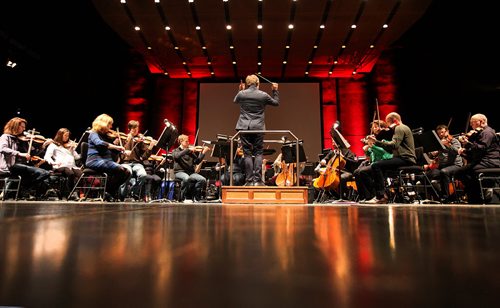 The Winnipeg Symphony Orchestra rehearses  the haunting, Breathing Black Ground, Thursday afternoon with Sarah Neufeld (front left in blue striped dress), part of the WSO new music festival.   Jan 29, 2015 Ruth Bonneville / Winnipeg Free Press