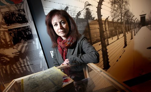 Belle Jarniewski poses in front of a mural of Auschwitz fences at the Holocaust Education Centre in the Asper Centre. She wrote a book chronically stories of Winnipeg survivors. ("Voices of Winnipeg Holocaust Survivors"). See Randy Turner's story. January 29, 2015 - (Phil Hossack / Winnipeg Free Press)