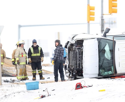 Springfield fire services and emergency workers around the upended truck involved in a collision at Dugald Road and the Perimeter Hwy Friday morning. Apparently there was more than one vehicle involved this was the one remaining at 1030. January 30, 2015 - (Phil Hossack / Winnipeg Free Press)