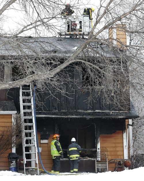 Winnipeg Fire Fighters at the scene of a townhouse fire at 1736 St. Mary's Rd. The fire was contained to one unit but it is a total lose. No one was in the unit when fire crews  arrived, two cats and two dogs may have perished, they have not been found . Wayne Glowacki/Winnipeg Free Press Jan. 30 2015