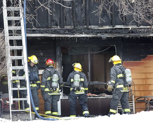 Winnipeg Fire Fighters at the scene of a townhouse fire at 1736 St. Mary's Rd. The fire was contained to one unit but it is a total lose. No one was in the unit when fire crews  arrived, two cats and two dogs may have perished they have not been found . Wayne Glowacki/Winnipeg Free Press Jan. 30 2015