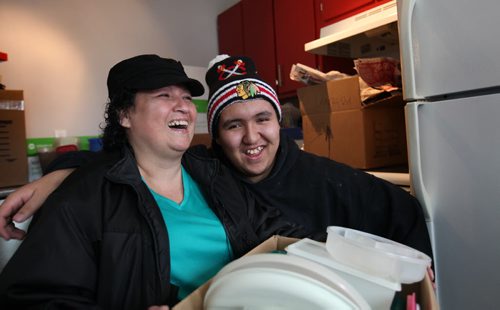 Shelly Peebles and her sixteen year old son Dylan are proud new home owners as they move into their  own home with assistance from the Manitoba Real Estate Association and Manitoba Tipi Mitawa Friday.  See Mary Agnes story.  Jan 30, 2015 Ruth Bonneville / Winnipeg Free Press