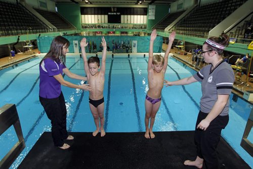 SPORTS - DIVING - (far L) Dallas Ludwick, head coach of Revolution Diving and coach Lindsey Wankling (far right). The boys diving are (L) Adam Cohen and (R) Eric Bisson, both 9. BORIS MINKEVICH / WINNIPEG FREE PRESS  Jan. 30, 2015