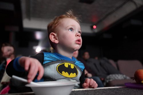 Two-year-old Andrew McCrae is glued to the large screen at Cinematheque Theatre as he watches retro cartoons with his mom and cousin in his batman pj's Saturday.   The theatre ran 3 hours of cartoons from the 60's through the 80's complete with sugary cereals, milk and popcorn.    Standup photo  Jan 31, 2015 Ruth Bonneville / Winnipeg Free Press