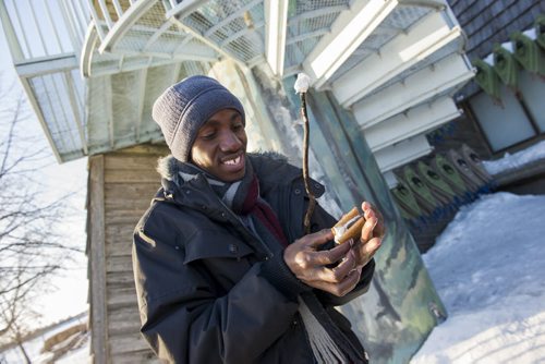 150131 Winnipeg - DAVID LIPNOWSKI / WINNIPEG FREE PRESS (January 31, 2015)  Collins Amutuhaire, an Environmental Architecture student from Uganda was one of about 60 International students new to Winnipeg from the International College of Manitoba, that got to experience winter for the first time at Fort Whyte Alive by participating in a digital scavenger hunt/geo cache. Here is prepares a amore.
