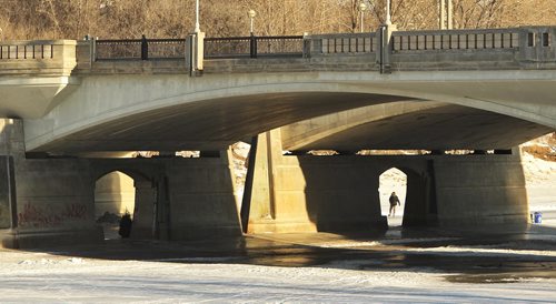 A skater makes their way under the Main Street Bridge along the River Trail on the Red River Sunday morning.  150201 February 01, 2015 Mike Deal / Winnipeg Free Press