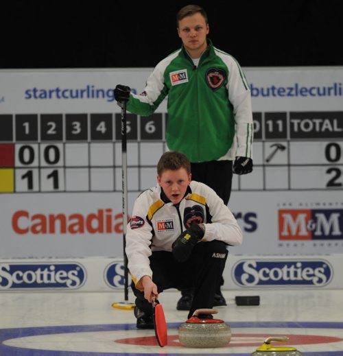 Corner Brook Nfld.February 1, 2015.M&M Meat Shops Canadian Jr.Curling Championship.Manitoba skip Braden Calvert (foreground) watches the incoming stone as opposing skip Jacob Hersikorn of Saskatoon Sk checks the line during the mens championship final game. michael burns photo