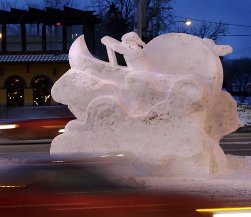 A snow sculpture of a voyageur in a sea of traffic Monday morning at the intersection of St.Mary's Rd. and Goulet St. for the upcoming Festival du Voyageur Feb.13-22.  Wayne Glowacki/Winnipeg Free Press Feb.2 2015