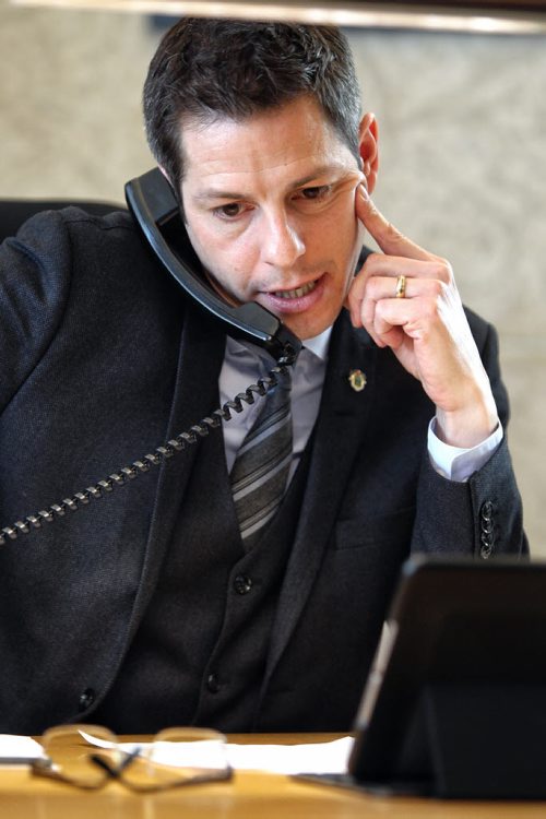 Mayor Brian Bowman at his desk in his office during the Town Hall teleconference which was recorded Monday morning. 150202 February 02, 2015 Mike Deal / Winnipeg Free Press