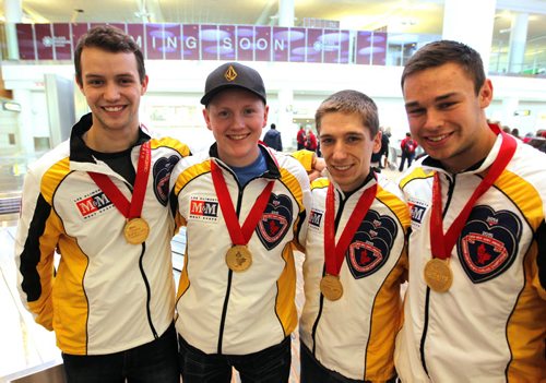 SPORTS - CURLING - Team Manitoba, Canadian champs arrive home, from left, lead Brendan Wilson, skip Braden Calvert, second Lucas Van Den Bosch and third Kyle Kurz. They pose for a photo at the the airport. BORIS MINKEVICH / WINNIPEG FREE PRESS  FEB 2, 2015